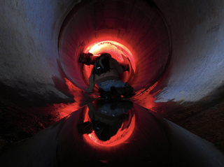 Illustration for article titled Unreal photographs of tunnels look like portals into the underworld